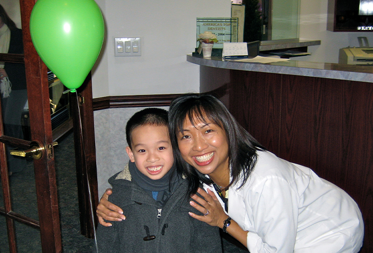 Dr. LaCap and smiling child in reception area