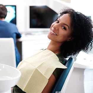 A woman smiling in the dentist’s chair