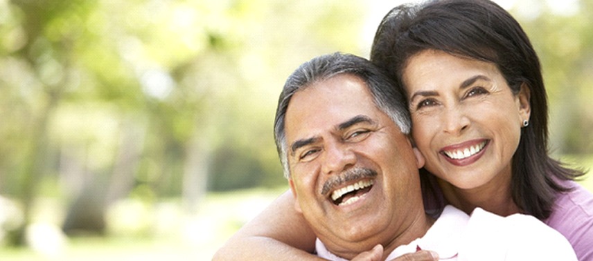 An older couple hugging and smiling