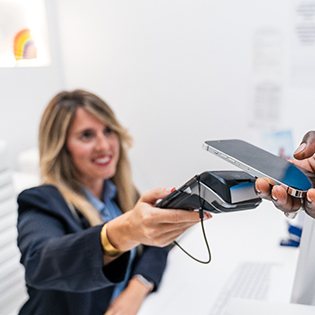 Dentist paying for treatment on phone
