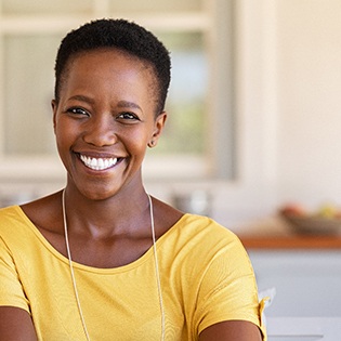 Woman in yellow shirt smiling