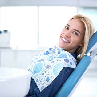 A young woman sitting in a dentist chair