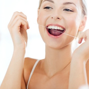 A woman flossing her teeth