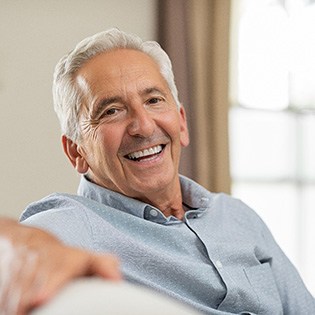 man smiling while sitting on couch