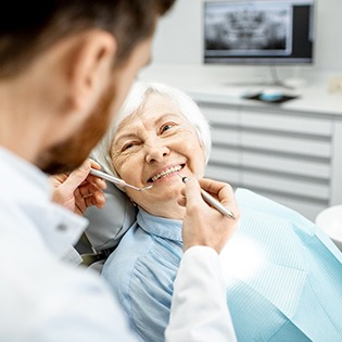 a patient smiling after paying the cost of dentures