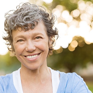 closeup of woman smiling while outside 