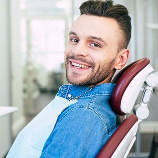 Man in denim jacket in dental chair