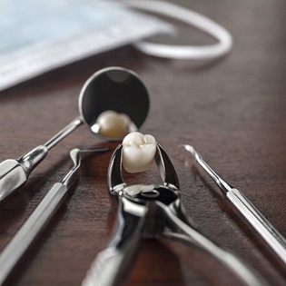 Dental instruments and an extracted tooth