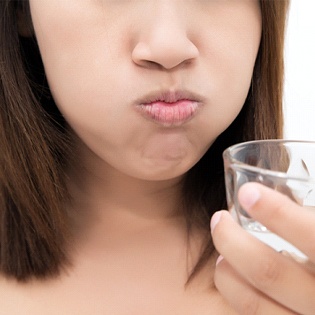 A woman rinsing with saltwater