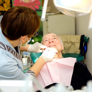 Dentist examining man’s smile in Tappan