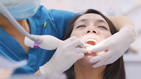 Dentist cleaning a patient’s gums