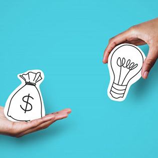 One hand holding a graphic of a money bag while the other holds a graphic of a light bulb