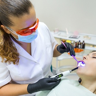 A female patient receiving an IV sedation as she undergoes a dental procedure