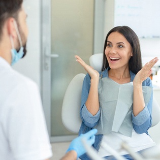 A woman thrilled with her results at the dentist’s office