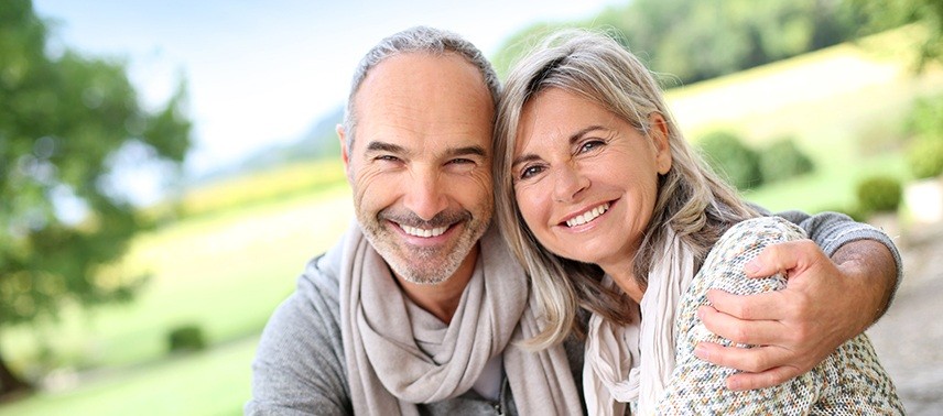 Smiling older man and woman outdoors