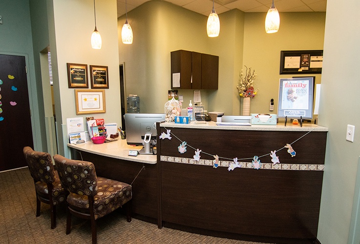 Dental treatment room with beige exam chair