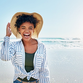 A young woman smiling while on the beach