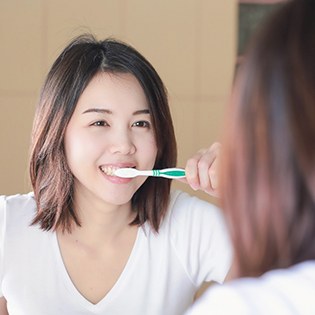 Young female brushing her teeth