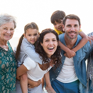 Family members of all ages smiling