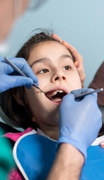 A dentist addresses a dental injury experienced by a young female patient in Tappan