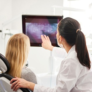Dentist looking at X-ray with patient during checkup