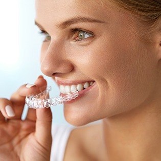 Woman placing clear aligner