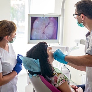 Dentist and patient looking at intraoral images