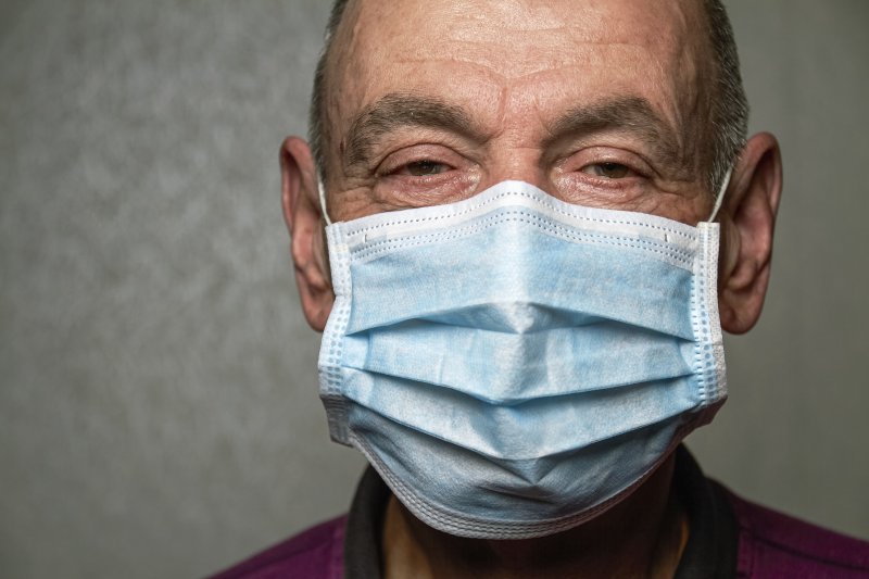 an older man wearing a face mask to protect himself against COVID-19