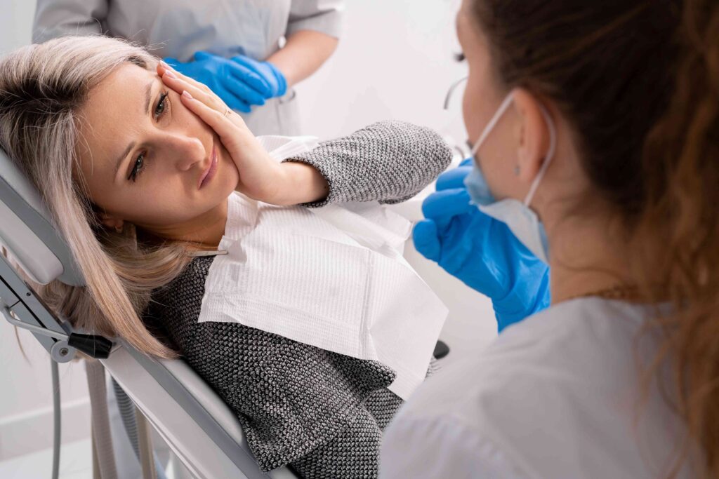 Woman with a toothache at the dentist