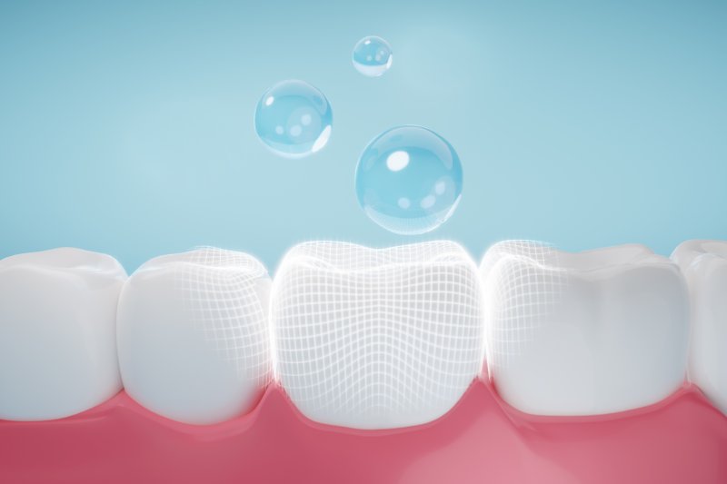 a 3D illustration of droplets going onto teeth